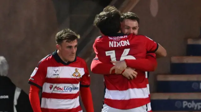 Glenn Middleton (right) is hugged by team-mate Tom Nixon after scoring