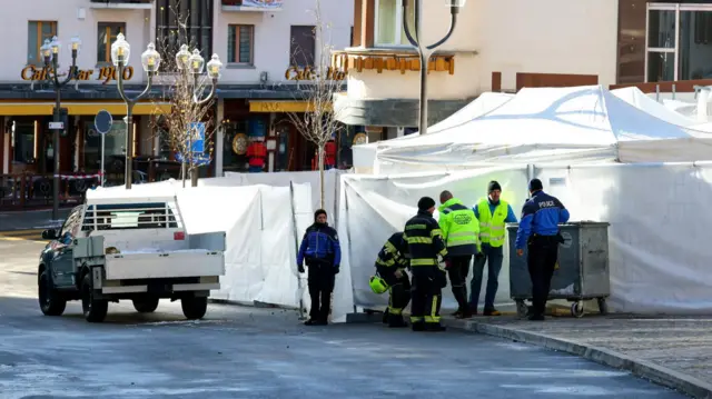 Workers outside forensic tent near bar