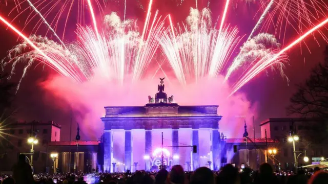 Pink and red fireworks over the Brandenburg Gate in Berlin, Germany