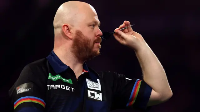Justin Hood throws a dart