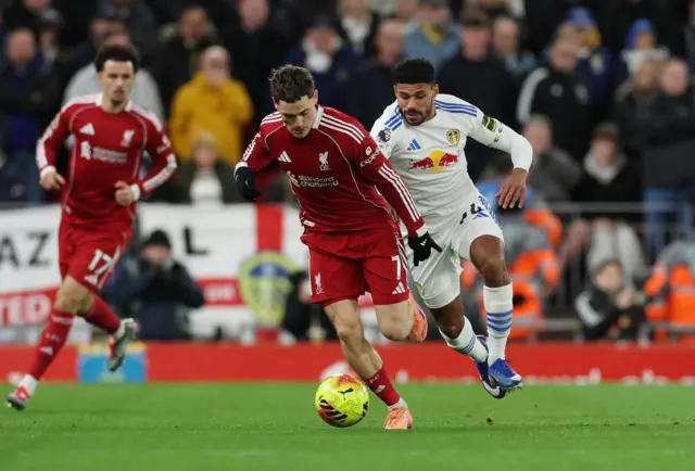 Liverpool's Florian Wirtz in action with Leeds United's James Justin