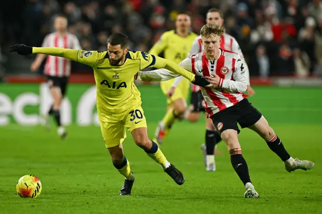 Tottenham Hotspur's Uruguayan midfielder #30 Rodrigo Bentancur (L) fights for the ball with Brentford's English striker #23 Keane Lewis-Potter