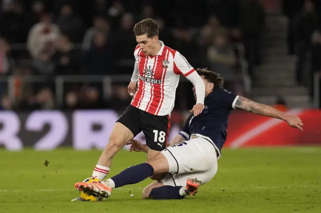 Millwall's Jake Cooper (right) challenges Southampton's Tom Fellows