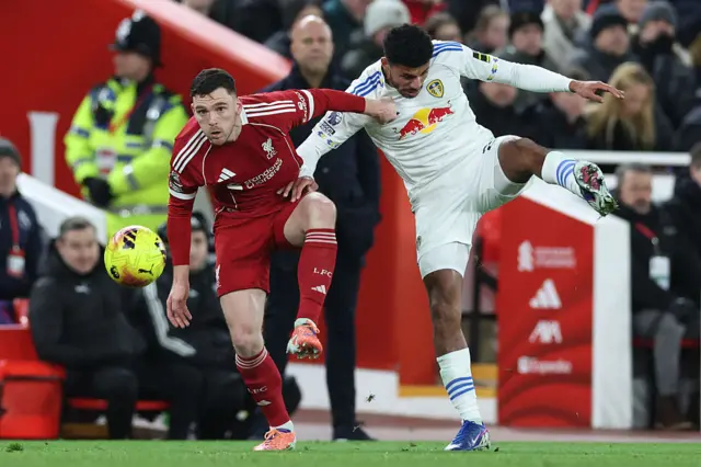 Liverpool's Scottish defender #26 Andrew Robertson (L) battles with Leeds United's English defender #24 James Justin