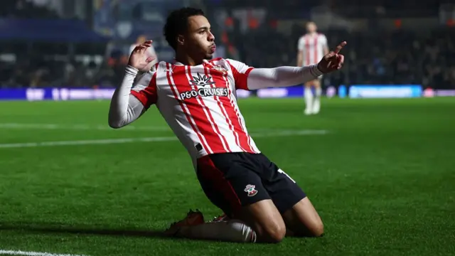 Cameron Archer slides on his knees in celebration after scoring