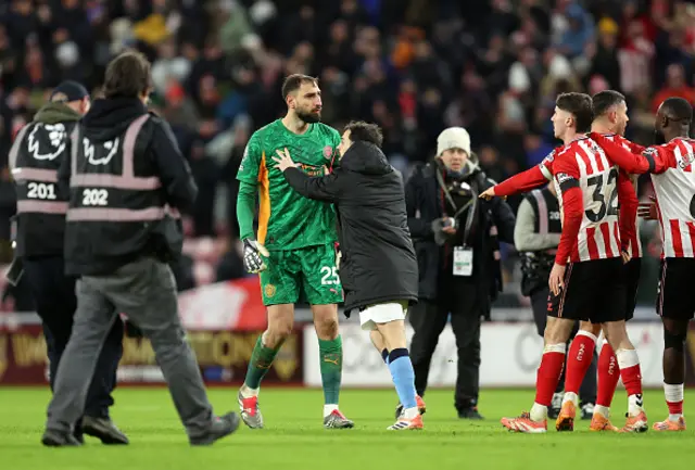 Gianluigi Donnarumma of Manchester City is guided away by teammate Bernardo Silva