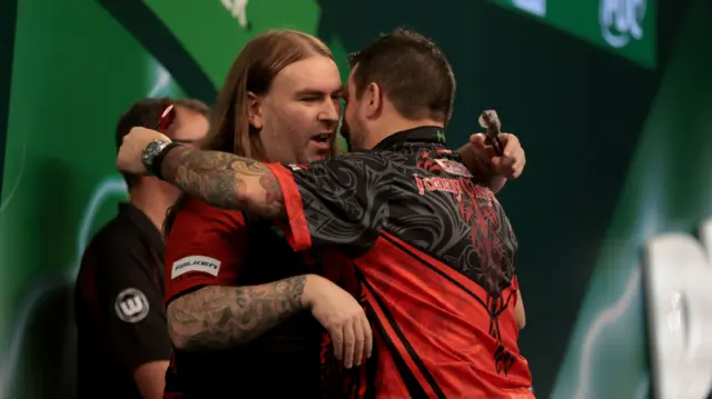 Ryan Searle embraces Jonny Clayton