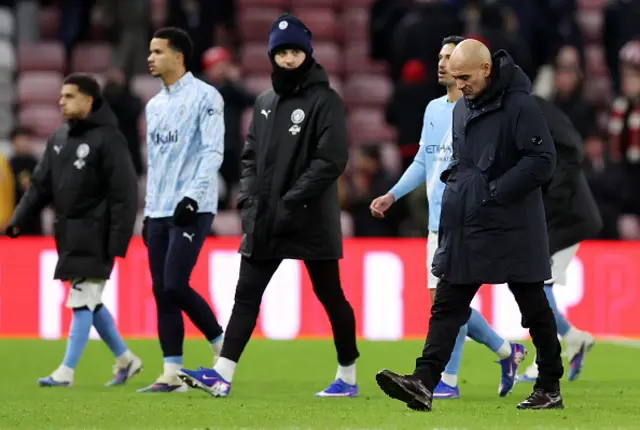 Pep Guardiola, Manager of Manchester City, looks dejected