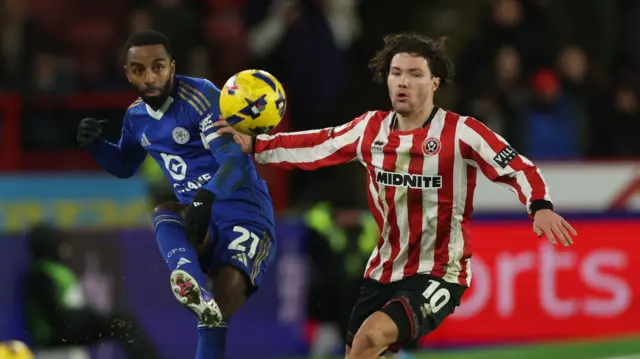 Calllum O'Hare (right) challenging for the ball alongside Domingos Ricardo Pereira who has his leg in the air as the ball bounces in the air