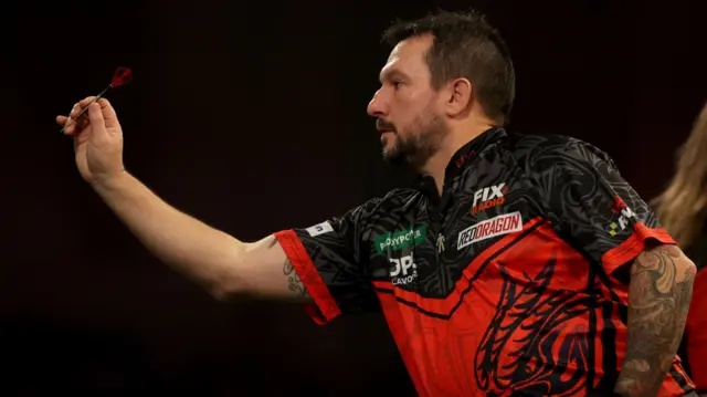 Jonny Clayton throws a dart