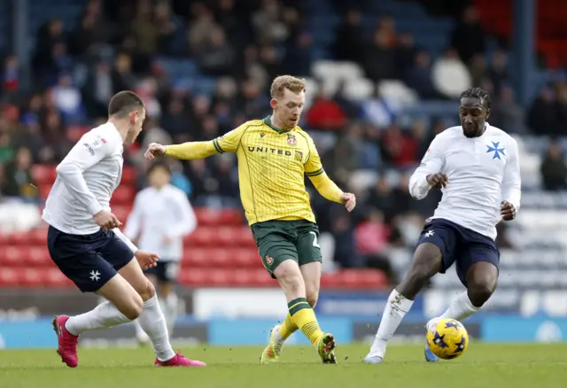 Wrexham's Lewis O'Brien passes the ball