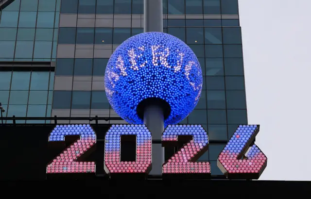 An enormous blue crystal ball in Times Square with "2026" underneath in red and blue crystals.