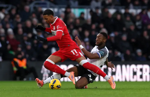 Morgan Whittaker of Middlesbrough is tackled by Ebou Adams of Derby County