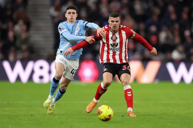 Granit Xhaka of Sunderland is put under pressure by Phil Foden