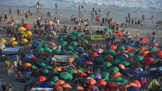 People enjoy the beach ahead of New Year's celebrations, at the Copacabana beach in Rio de Janeiro, Brazi
