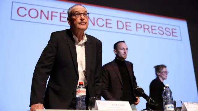 Swiss President Guy Parmelin stands at a press conference