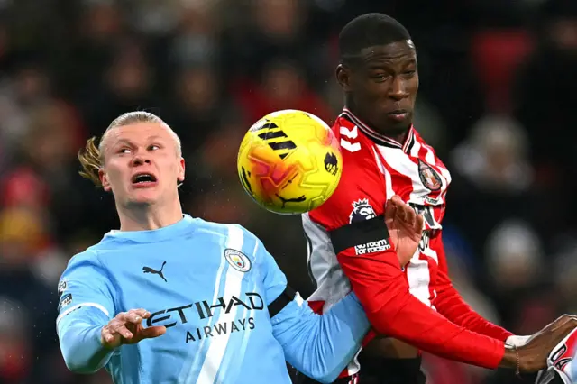 Manchester City's Norwegian striker #09 Erling Haaland (L) jumps against Sunderland's French defender #20 Nordi Mukiele