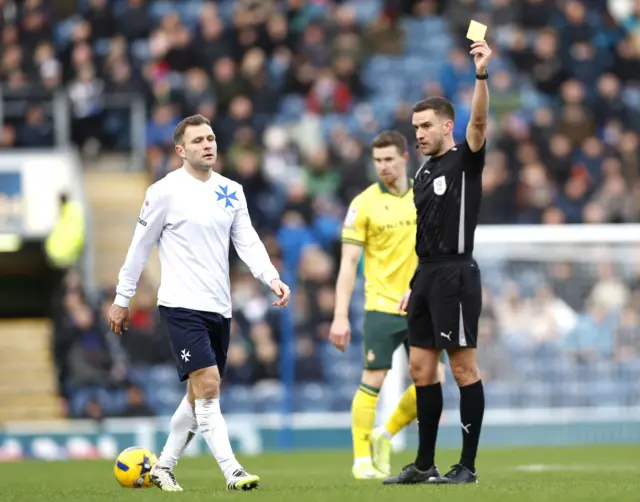 Blackburn Rovers' Sondre Tronstad is shown a yellow card by referee Thomas Kirk