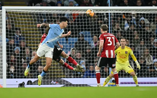 Nico O'Reilly heads the ball