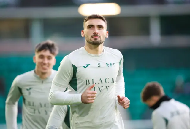 Hibs defender Warren O'Hora warming up