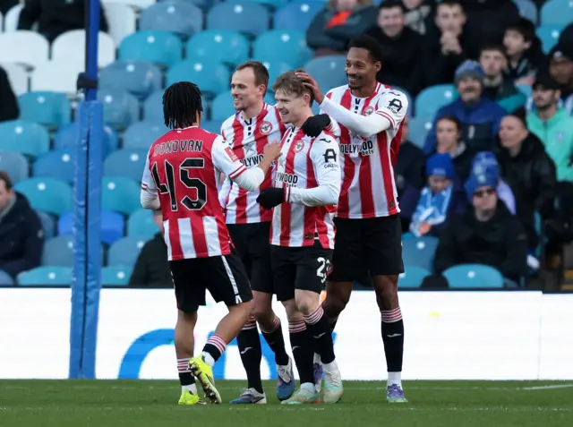 Keane Lewis-Potter celebrates with his teammates