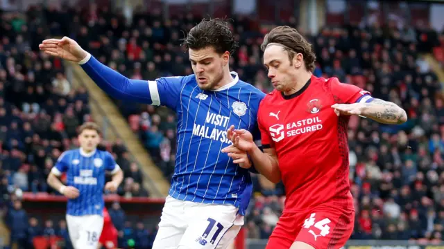 Ollie Tanner of Cardiff City and Theo Archibald of Leyton Orient compete for the ball