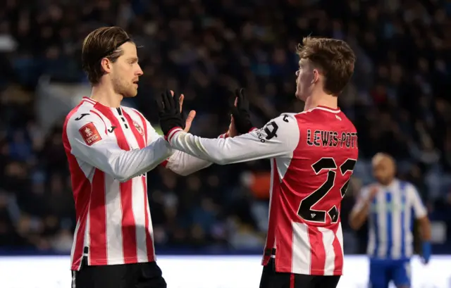 Keane Lewis Potter and Mathias Jensen celebrate