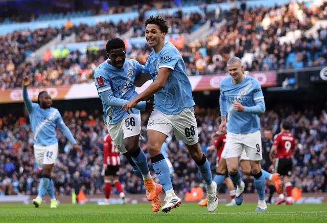 Max Alleyne celebrates with Ryan McAidoo