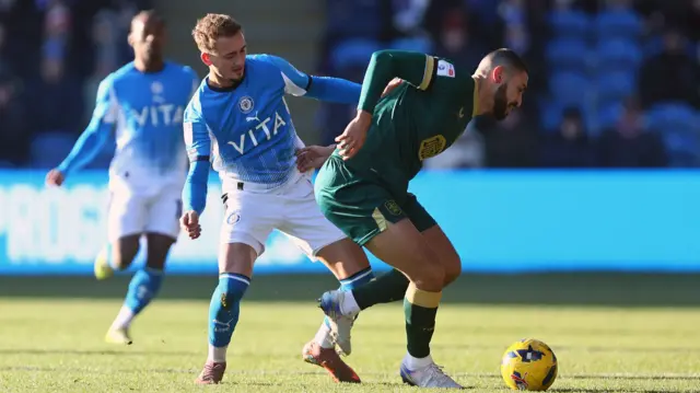 Jack Diamond of Stockport County and Radinio Balker of Huddersfield Town battle for possession