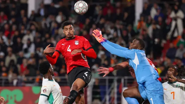 Hossam Abdelmaguid heads the ball in front of Ivory Coast goalkeeper Yahia Fofana