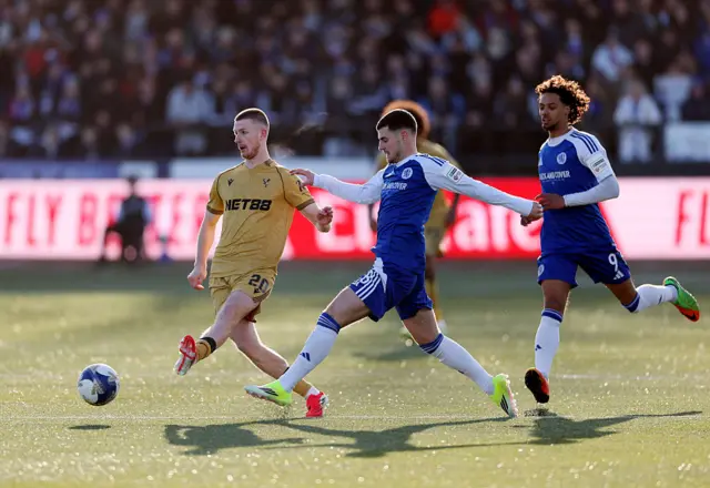 : Adam Wharton of Crystal Palace passes the ball whilst under pressure from James Edmondson of Macclesfield