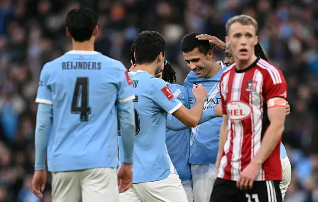 Rodri celebrates with his teammates