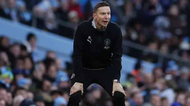 Pep Lijnders with hands on knees during Man City's win over Exeter