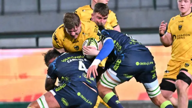 Matthew Screech of Dragons is tackled by Matteo Canali of Benetton