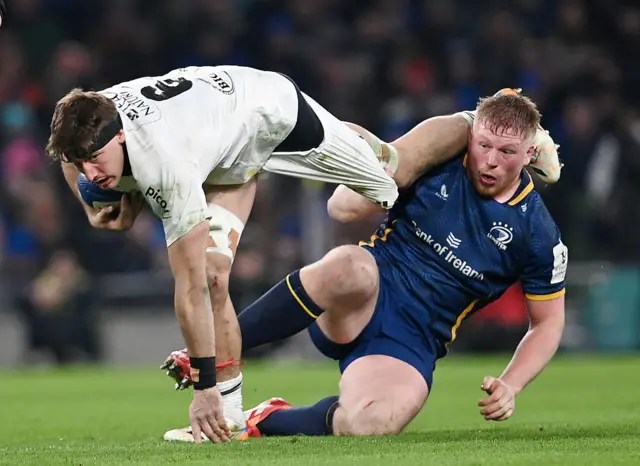 Paddy McCarthy of Leinster Rugby tackles Oscar Jegou