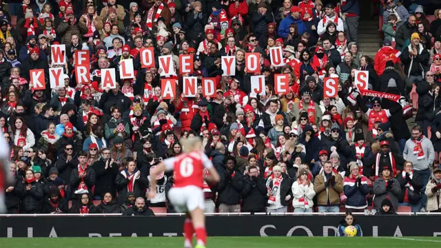 Arsenal supporters showing signs for Cooney-Cross