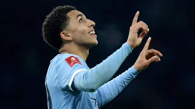 Rico Lewis points to the sky after scoring against Exeter