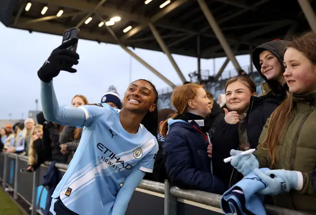Kerolin Nicoli takes pictures with Manchester City fans