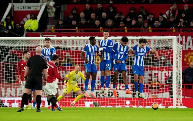 Bruno Fernandes watches the Brighton wall jump over his shot