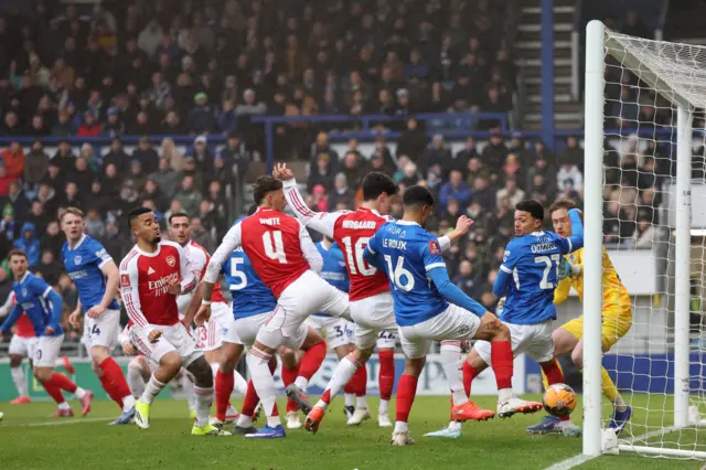 Players from both sides scramble for the ball near the goalline