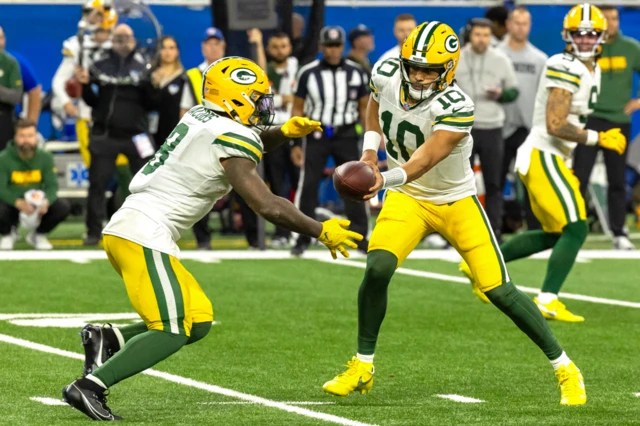 Jordan Love hands the ball to Josh Jacobs of the Green Bay Packers