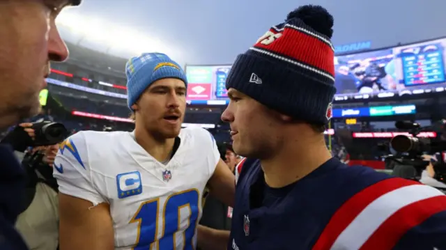 Justin Herbert speaking to Drake Maye after the Los Angeles Chargers victory over the New England Patriots in December 2024