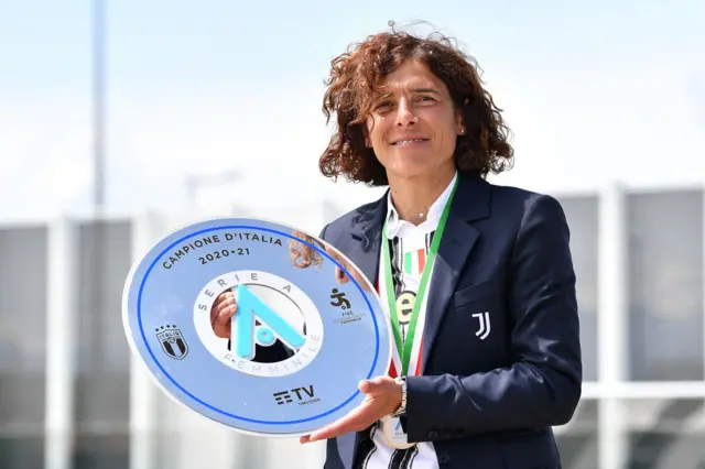 Rita Guarino holds up the Serie A Femminile title