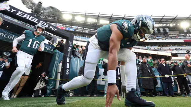 Philadelphia Eagles quarterback Jalen Hurts touches the field before the 2025 NFL play-off game against the San Francisco 49ers