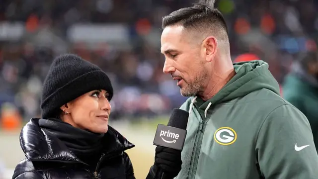 Kaylee Hartung interviews head coach Matt LaFleur of the Green Bay Packers at half-time against the Chicago Bears