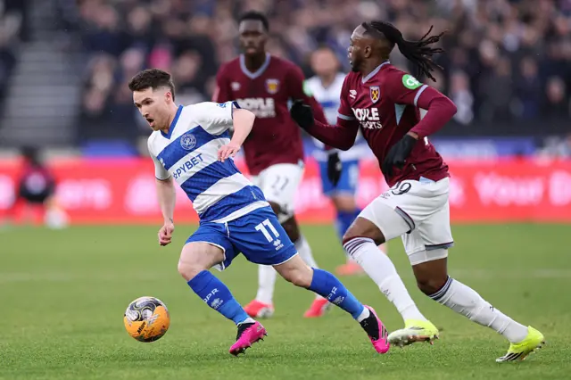 Paul Smyth holds off the challenge of Aaron Wan Bissaka