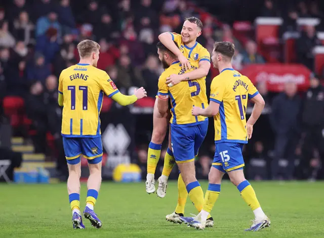 Louis Reed celebrates with his teammates