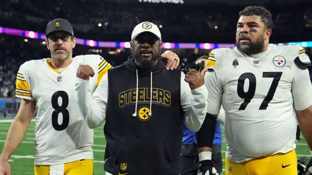 Quarterback Aaron Rodgers with Pittsburgh Steelers head coach Mike Tomlin and team-mate Cameron Heyward
