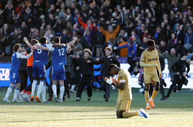 Marc Guehi looks dejected as Macclesfield F.C. players celebrate