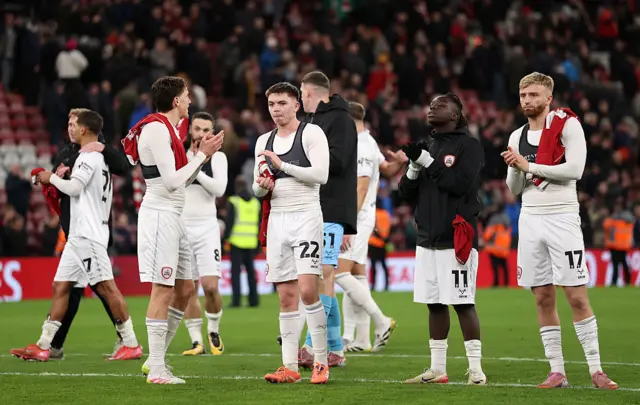 Barnsley players clap their fans at the end of the game